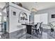 Stylish dining area with elegant chandelier, gray walls, a modern table, and bar access at 8216 Brittany Harbor Dr, Las Vegas, NV 89128
