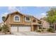Charming two-story home featuring a tile roof, stucco exterior, and well-maintained landscaping at 8216 Brittany Harbor Dr, Las Vegas, NV 89128