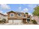 Two-story home features a three-car garage and manicured front yard at 8216 Brittany Harbor Dr, Las Vegas, NV 89128