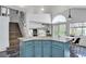 Kitchen island with granite countertops and cabinets that flow into the dining area with sliding door access to the backyard at 8216 Brittany Harbor Dr, Las Vegas, NV 89128