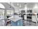Bright kitchen features stainless appliances, granite counters, custom cabinets, and eat-in table at 8216 Brittany Harbor Dr, Las Vegas, NV 89128