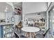The kitchen with granite countertops, stainless steel appliances, and island barstool seating flows into the dining and living areas at 8216 Brittany Harbor Dr, Las Vegas, NV 89128