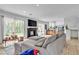 Bright and inviting living room with access to the backyard, featuring a cozy fireplace and comfortable seating at 8216 Brittany Harbor Dr, Las Vegas, NV 89128
