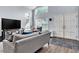 Spacious living room featuring high ceilings, large windows, tile entrance and a comfortable gray sofa at 8216 Brittany Harbor Dr, Las Vegas, NV 89128