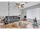 Bright living room with a ceiling fan, window blinds and fun accessories at 8216 Brittany Harbor Dr, Las Vegas, NV 89128