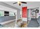 Open-concept floor plan with hardwood floors, climbing wall and two couches at 8216 Brittany Harbor Dr, Las Vegas, NV 89128