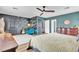 Primary bedroom with ceiling fan, wallpapered accent wall and ensuite doors at 8216 Brittany Harbor Dr, Las Vegas, NV 89128