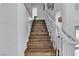 Staircase with hardwood floors and a white railing at 8216 Brittany Harbor Dr, Las Vegas, NV 89128