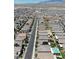 Expansive aerial view of a neighborhood featuring a pool and play area at 8724 Scalpay St, Las Vegas, NV 89166