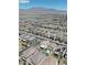 Expansive aerial view of a neighborhood with mountain views in the background at 8724 Scalpay St, Las Vegas, NV 89166