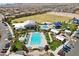 An aerial view of the community pool, recreational areas, and surrounding neighborhood at 8724 Scalpay St, Las Vegas, NV 89166