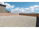 Gravel backyard with a tall block wall, great for customization and creating your ideal outdoor living space at 8724 Scalpay St, Las Vegas, NV 89166