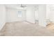 Spacious bedroom with neutral carpet, ceiling fan, and bathroom entrance at 8724 Scalpay St, Las Vegas, NV 89166