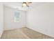 Bedroom with a neutral color palette, window, ceiling fan, and carpet flooring at 8724 Scalpay St, Las Vegas, NV 89166