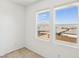 Sunlit bedroom with neutral carpet, offering scenic neighborhood views from windows at 8724 Scalpay St, Las Vegas, NV 89166