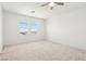 Bright bedroom featuring neutral carpeting and a view from two windows at 8724 Scalpay St, Las Vegas, NV 89166
