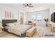 Staged bedroom with a queen bed, ensuite bathroom, scenic view, and modern decor at 8724 Scalpay St, Las Vegas, NV 89166