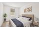 Cozy bedroom with a minimalist design, featuring a comfortable bed, neutral tones, and modern artwork at 8724 Scalpay St, Las Vegas, NV 89166