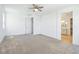 Spacious bedroom featuring neutral carpet and bathroom entrance at 8724 Scalpay St, Las Vegas, NV 89166