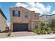 Charming two-story home with desert landscaping, a brick driveway, and attached two-car garage at 8724 Scalpay St, Las Vegas, NV 89166