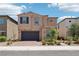 Charming two-story home with desert landscaping, a brick driveway, and attached two-car garage at 8724 Scalpay St, Las Vegas, NV 89166