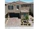 Charming two-story home with desert landscaping, a brick driveway, and attached two-car garage at 8724 Scalpay St, Las Vegas, NV 89166