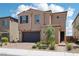Charming two-story home with desert landscaping, a brick driveway, and attached two-car garage at 8724 Scalpay St, Las Vegas, NV 89166