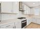 Close up of the white counters, cabinets, and backsplash at 8724 Scalpay St, Las Vegas, NV 89166