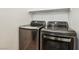 This laundry room showcases a modern washer and dryer set with sleek designs at 8724 Scalpay St, Las Vegas, NV 89166