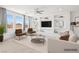 Modern living room showcasing built-in shelving, stylish furniture, and ample natural light through large windows at 8724 Scalpay St, Las Vegas, NV 89166
