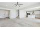 Spacious living area featuring neutral carpet, open floor plan, and staircase access at 8724 Scalpay St, Las Vegas, NV 89166