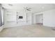Large living room with built-in shelving, neutral carpet, and recessed lighting fixtures at 8724 Scalpay St, Las Vegas, NV 89166