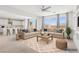 Bright living room with neutral tones, modern furniture, and an open concept design with kitchen access at 8724 Scalpay St, Las Vegas, NV 89166