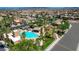 Aerial view of community pool, amenities, park, and lush landscaping in residential neighborhood at 9215 Penn Station St, Las Vegas, NV 89123