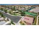 Aerial view highlighting community amenities including a playground, tennis courts, and open green spaces at 9215 Penn Station St, Las Vegas, NV 89123