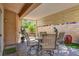 Back patio offers a covered space with pavers, outdoor furniture, and manicured landscaping at 9215 Penn Station St, Las Vegas, NV 89123