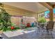 Covered back patio featuring a stone-paver floor, table with chairs, and plants at 9215 Penn Station St, Las Vegas, NV 89123
