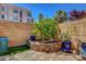 Backyard oasis with a stone-paved area, lush greenery, and manicured landscaping at 9215 Penn Station St, Las Vegas, NV 89123