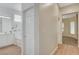 Bright hallway leading to bathroom with double sinks, a large tub, and tiled floors at 9215 Penn Station St, Las Vegas, NV 89123