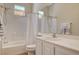 Well-lit bathroom boasting a shower-tub combo and a spacious vanity with a sink at 9215 Penn Station St, Las Vegas, NV 89123