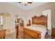 Primary bedroom with antique wood furniture, neutral walls, carpet flooring, and mirrored closet at 9215 Penn Station St, Las Vegas, NV 89123