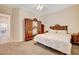 Bedroom featuring a decorative headboard, wardrobe, carpeted floors and neutral walls at 9215 Penn Station St, Las Vegas, NV 89123