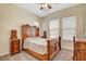 Bedroom featuring ornate wood furniture, neutral walls, carpet flooring and natural lighting at 9215 Penn Station St, Las Vegas, NV 89123