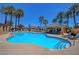 Upscale community pool and spa with lounge chairs, palm trees, and relaxing resort-style amenities at 9215 Penn Station St, Las Vegas, NV 89123