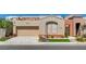 Single-story home showcasing a two-car garage, desert landscaping, and a neutral color palette at 9215 Penn Station St, Las Vegas, NV 89123