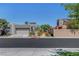 Contemporary home showcasing desert landscaping, a two-car garage, and stylish architectural details at 9215 Penn Station St, Las Vegas, NV 89123