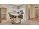 Bright kitchen featuring white cabinetry, an island, stainless steel appliances and wood flooring at 9215 Penn Station St, Las Vegas, NV 89123