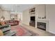 Bright living room showcasing a fireplace, built-in shelving, and comfortable leather seating on wood floors at 9215 Penn Station St, Las Vegas, NV 89123