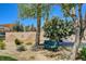 Green bench and blooming trees create a serene spot in this well-maintained community park at 9215 Penn Station St, Las Vegas, NV 89123
