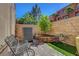 Cozy brick patio featuring an iron bench, landscaped planter, and serene outdoor living space at 9215 Penn Station St, Las Vegas, NV 89123